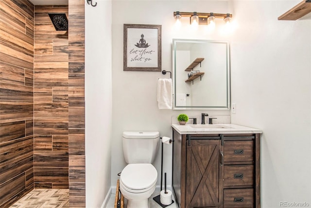 bathroom featuring a shower, vanity, and toilet