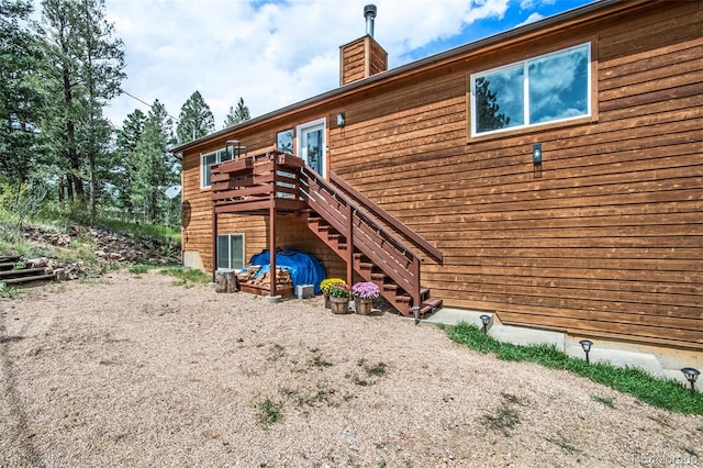 back of house featuring a deck