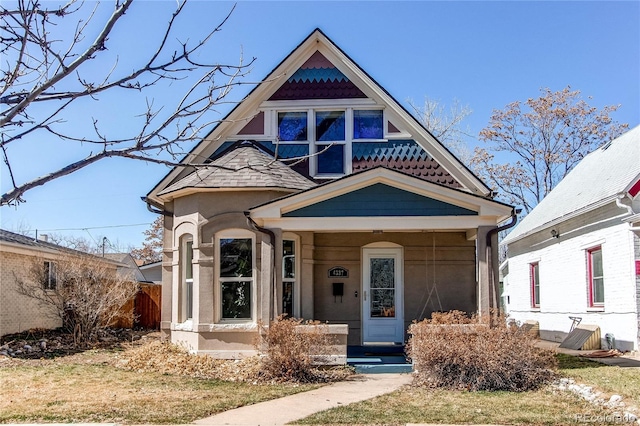 victorian-style house featuring stucco siding