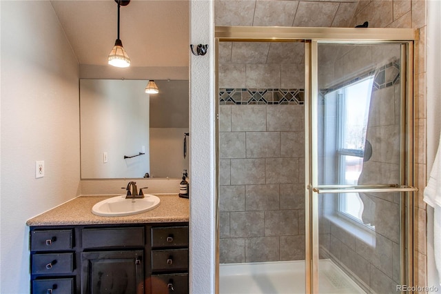 full bathroom featuring plenty of natural light, a shower stall, and vanity