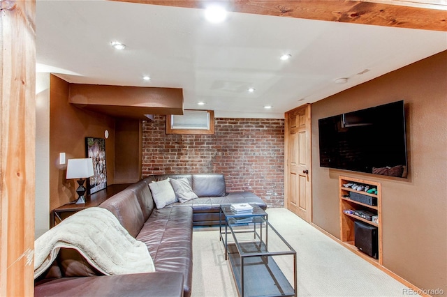 living area featuring recessed lighting, carpet, and brick wall