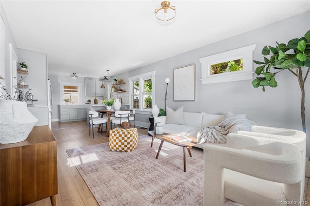 living area featuring light wood finished floors and baseboards