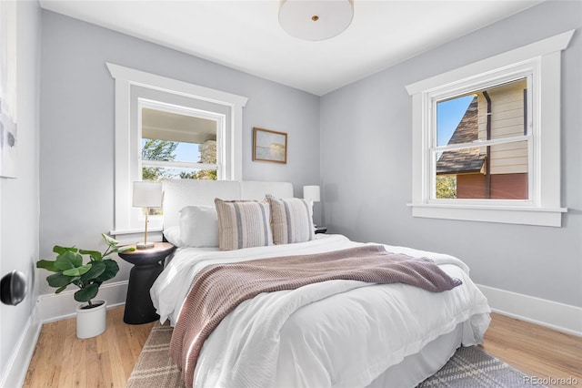 bedroom with baseboards and wood finished floors
