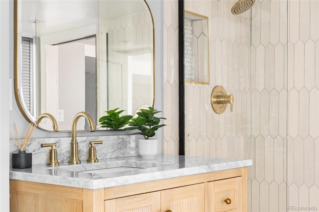bathroom with vanity and tiled shower