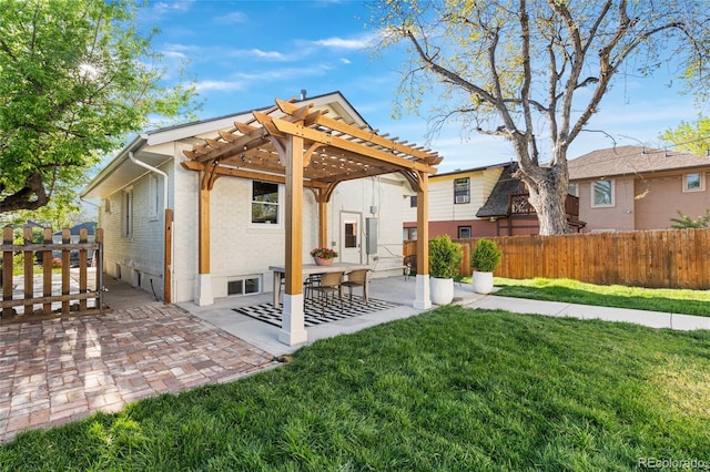 rear view of property featuring a pergola and a patio area