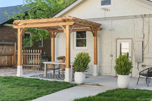 view of patio with a pergola and fence
