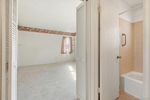 bathroom with plus walk in shower and a textured ceiling