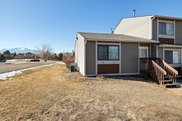 rear view of house featuring cooling unit