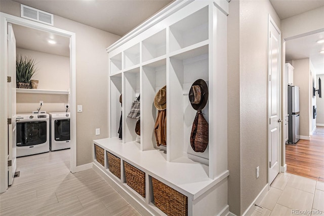 mudroom featuring separate washer and dryer