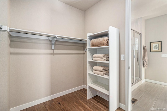 spacious closet featuring hardwood / wood-style flooring