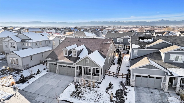 snowy aerial view with a mountain view