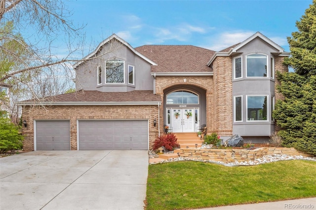 10773 Cougar Rdg, Lone Tree, CO 80124 - view of front of home with a shingled roof, concrete driveway, a front yard, an attached garage, and stucco siding
