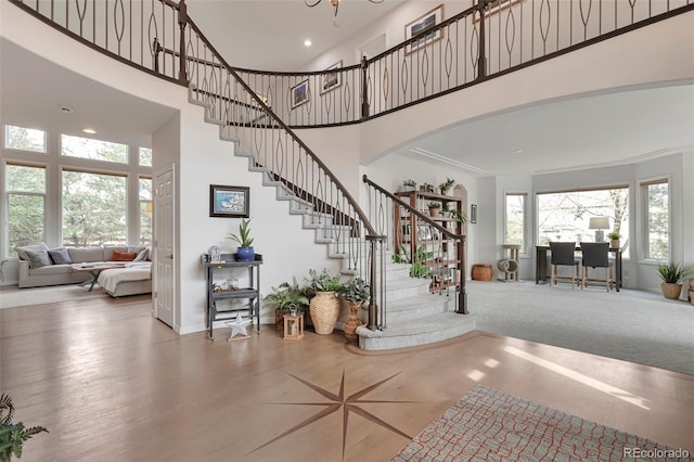 10773 Cougar Rdg, Lone Tree, CO 80124 - foyer with a towering ceiling, stairs, baseboards, arched walkways, and recessed lighting