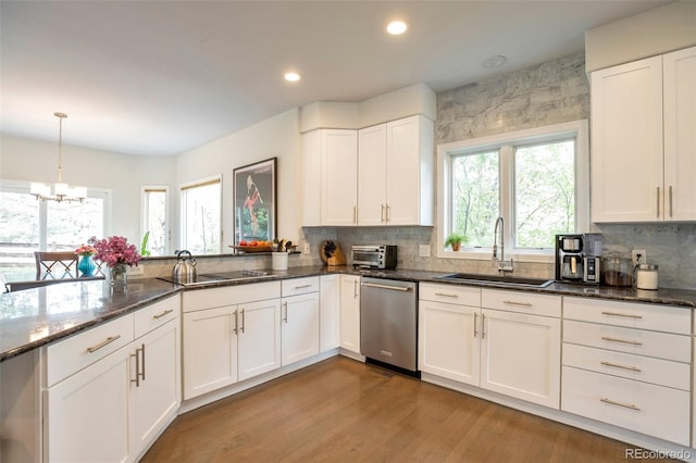 10773 Cougar Rdg, Lone Tree, CO 80124 - kitchen with a sink, dishwasher, plenty of natural light, a chandelier, and recessed lighting