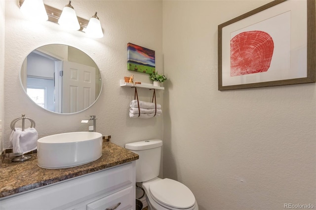 10773 Cougar Rdg, Lone Tree, CO 80124 - bathroom with toilet, vanity, and a textured wall