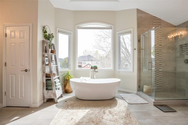 10773 Cougar Rdg, Lone Tree, CO 80124 - bathroom with tile patterned flooring, a stall shower, a freestanding bath, and baseboards