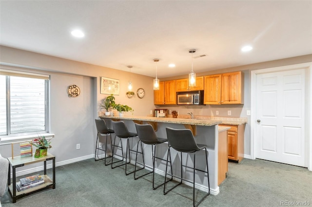 10773 Cougar Rdg, Lone Tree, CO 80124 - kitchen featuring a kitchen bar, stainless steel microwave, carpet, and recessed lighting