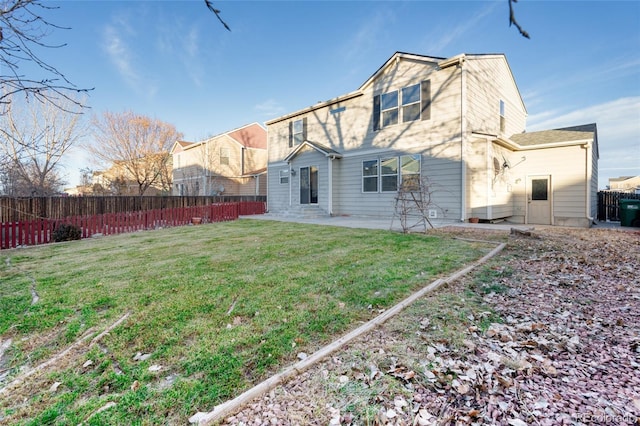 rear view of property featuring a yard and a patio area