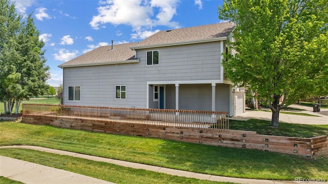 back of house with concrete driveway