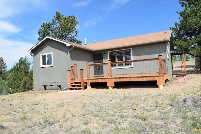 rear view of property with a wooden deck