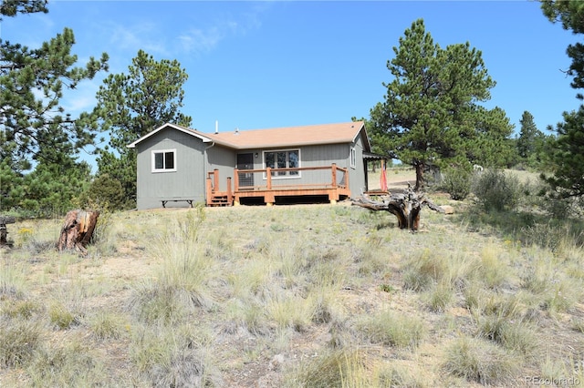 back of house featuring a wooden deck