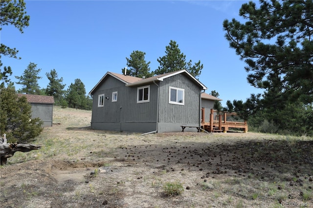 view of side of property featuring a wooden deck