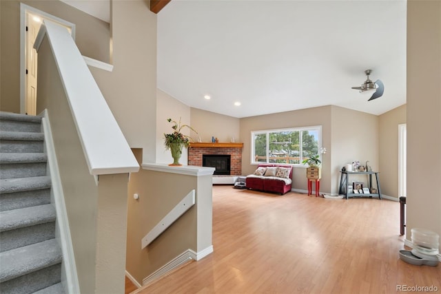 3390 S Ensenada Way, Aurora, CO 80013 - stairs featuring wood finished floors, ceiling fan, vaulted ceiling, a fireplace, and recessed lighting