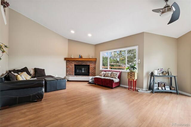 3390 S Ensenada Way, Aurora, CO 80013 - living area with lofted ceiling, a ceiling fan, light wood-style floors, recessed lighting, and a fireplace