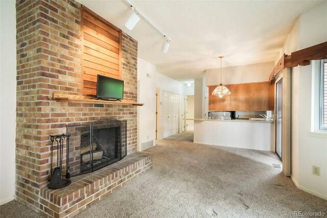 5010 Sunsuite Trl, Colorado Springs, CO 80917 - unfurnished living room with carpet, baseboards, a fireplace, and a sink