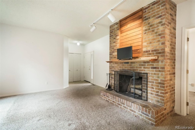 5010 Sunsuite Trl, Colorado Springs, CO 80917 - unfurnished living room with carpet floors, a fireplace, baseboards, and track lighting