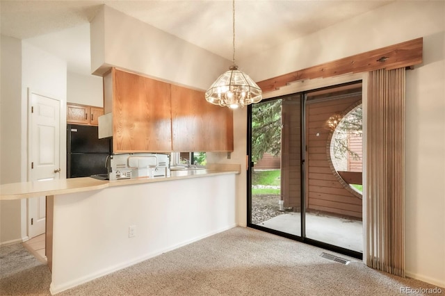 5010 Sunsuite Trl, Colorado Springs, CO 80917 - kitchen with freestanding refrigerator, light carpet, a chandelier, and light countertops