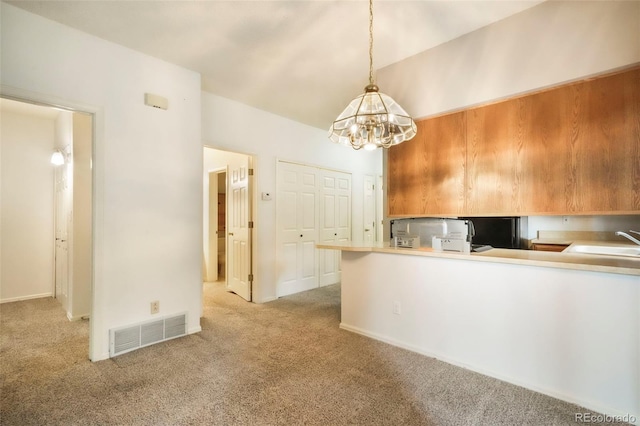 5010 Sunsuite Trl, Colorado Springs, CO 80917 - kitchen with carpet flooring, a chandelier, a sink, and pendant lighting