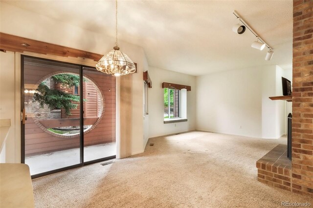 5010 Sunsuite Trl, Colorado Springs, CO 80917 - unfurnished living room featuring carpet flooring and a chandelier