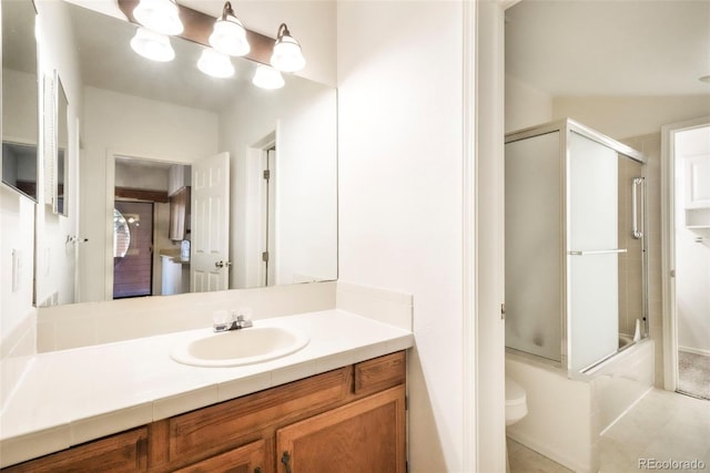 5010 Sunsuite Trl, Colorado Springs, CO 80917 - bathroom with vanity, toilet, combined bath / shower with glass door, and tile patterned flooring