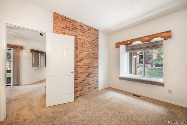 5010 Sunsuite Trl, Colorado Springs, CO 80917 - carpeted spare room featuring plenty of natural light, brick wall, and baseboards