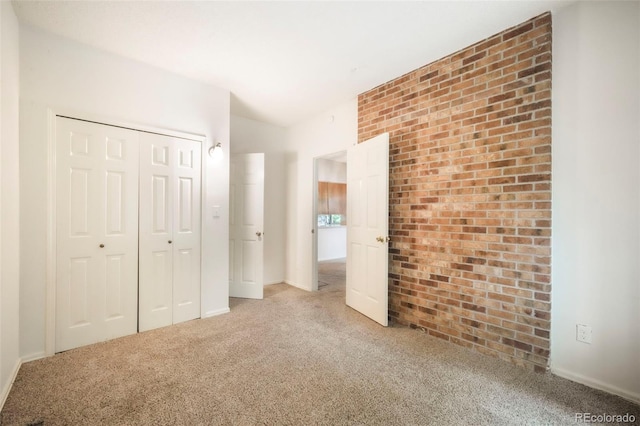5010 Sunsuite Trl, Colorado Springs, CO 80917 - unfurnished bedroom with carpet, a closet, and brick wall