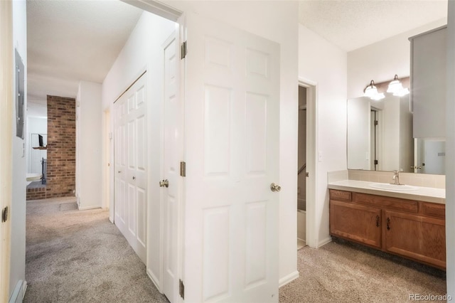 5010 Sunsuite Trl, Colorado Springs, CO 80917 - hallway featuring a sink, light colored carpet, and baseboards