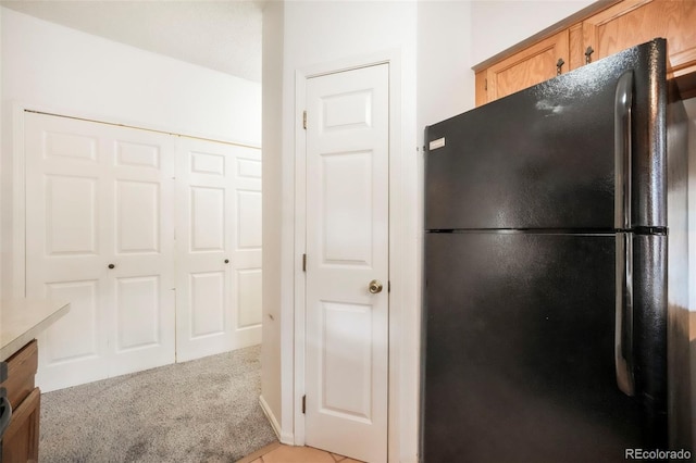 5010 Sunsuite Trl, Colorado Springs, CO 80917 - kitchen with freestanding refrigerator and light carpet