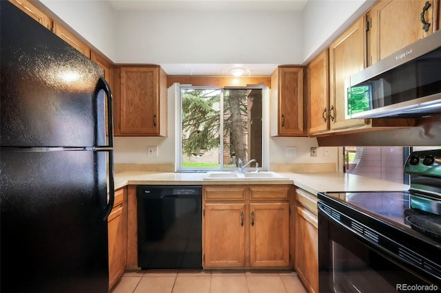 5010 Sunsuite Trl, Colorado Springs, CO 80917 - kitchen featuring black appliances, a sink, light countertops, and light tile patterned flooring