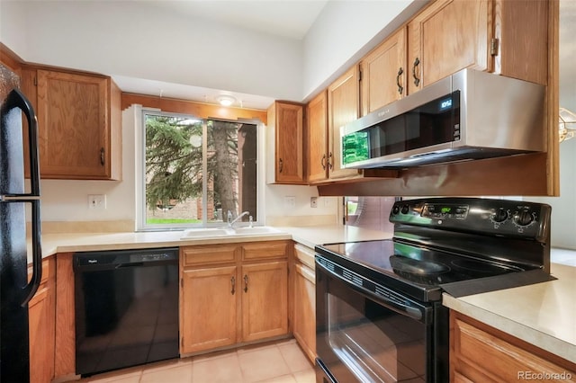 5010 Sunsuite Trl, Colorado Springs, CO 80917 - kitchen with black appliances, a sink, light countertops, and light tile patterned flooring