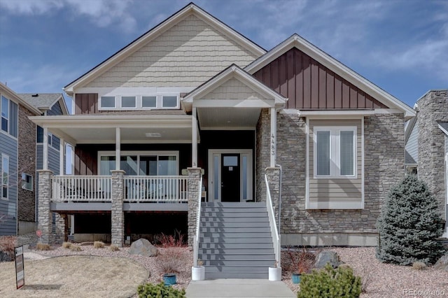 craftsman house with a porch, board and batten siding, and stone siding