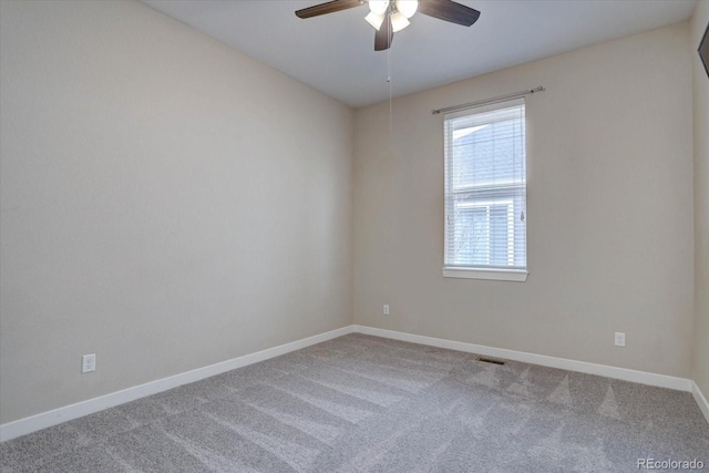 empty room with visible vents, baseboards, ceiling fan, and carpet flooring