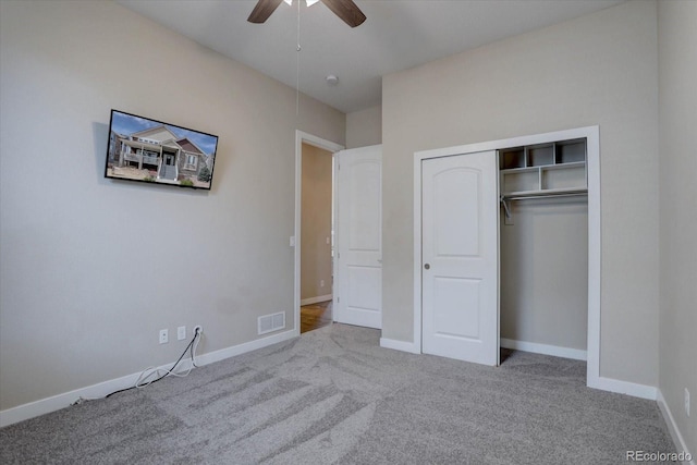 unfurnished bedroom with carpet flooring, baseboards, visible vents, and a closet