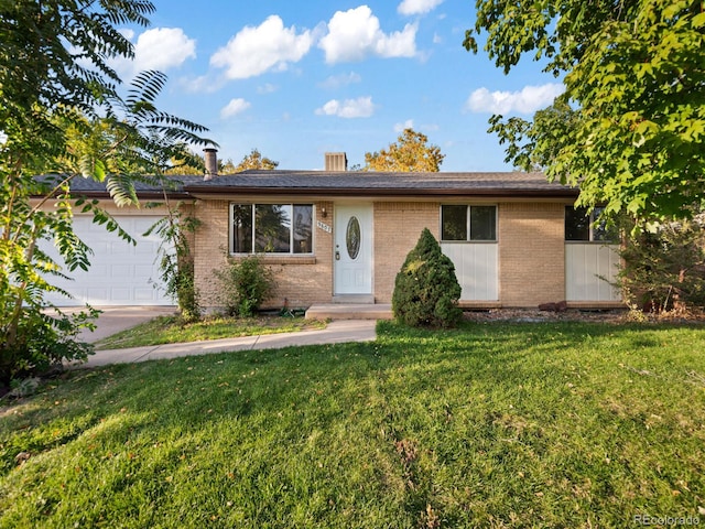 view of front of property featuring a garage and a front lawn