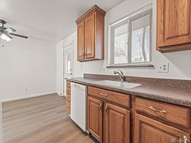 kitchen with ceiling fan, sink, white dishwasher, and light hardwood / wood-style floors