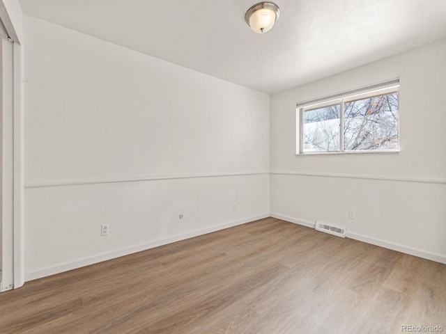 spare room with hardwood / wood-style flooring