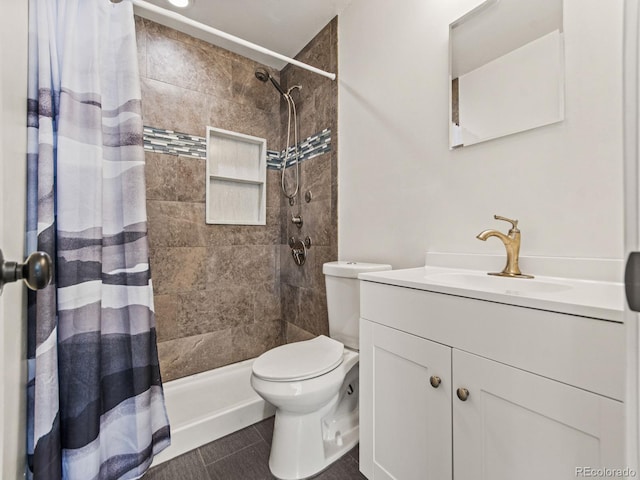 bathroom featuring vanity, toilet, and walk in shower