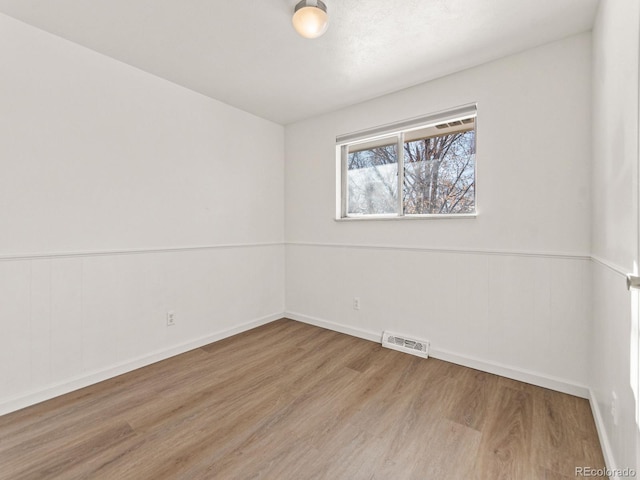 spare room featuring light hardwood / wood-style flooring