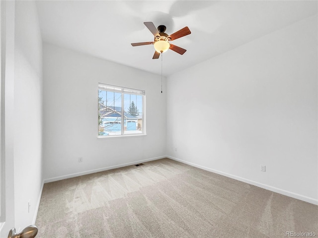 carpeted spare room with ceiling fan