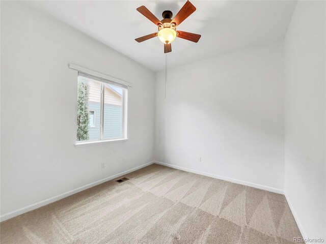 spare room with carpet floors and ceiling fan